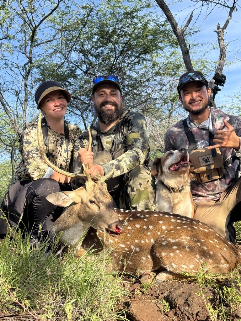 Hunting party with a harvested axis deer on Molokai, Hawaii