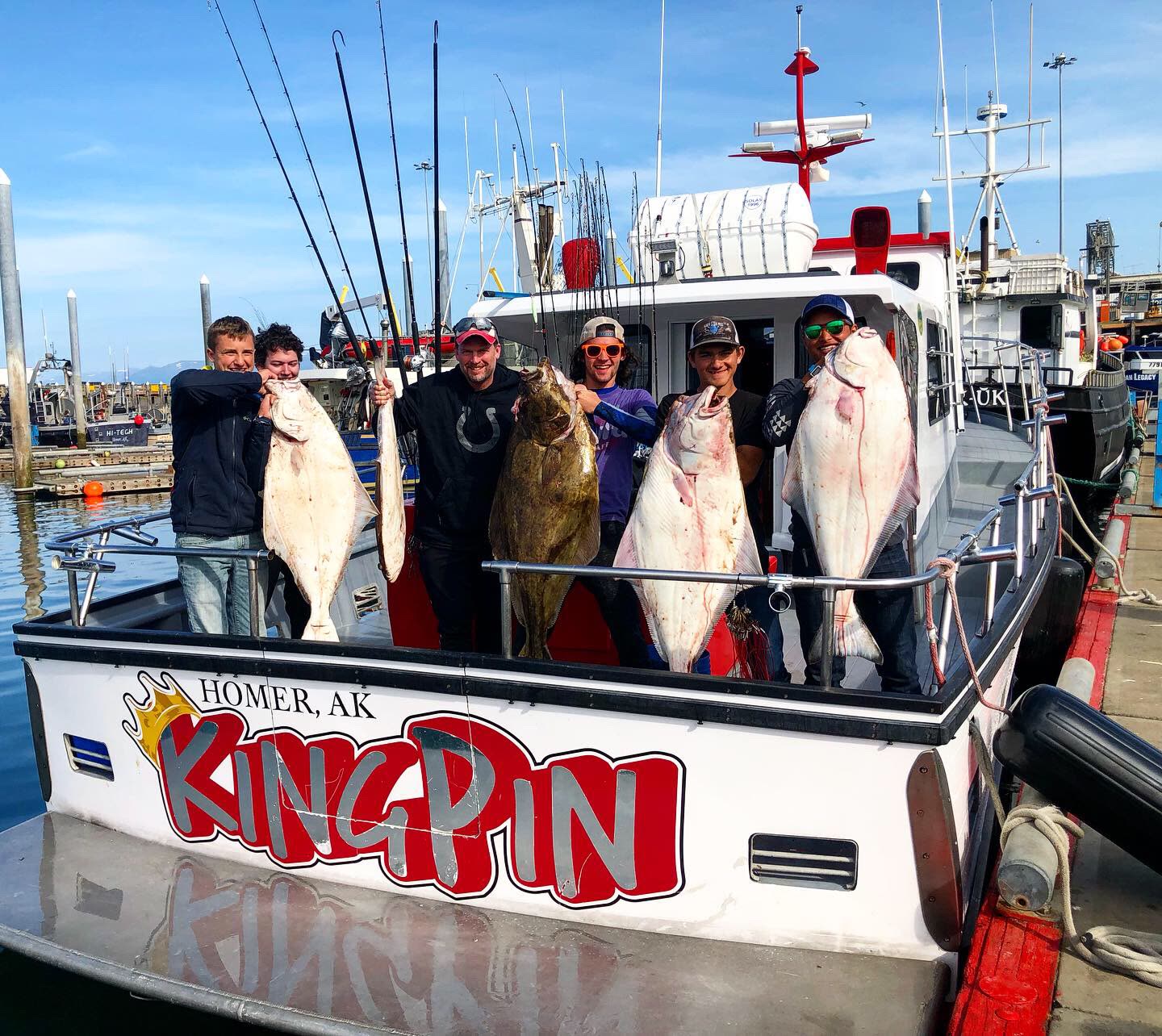 A full Alaska fishing crew poses aboard the King Pin with halibut and rockfish from the day’s catch.